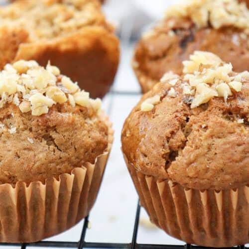 Carrot cake muffins cooling on a wire rack.