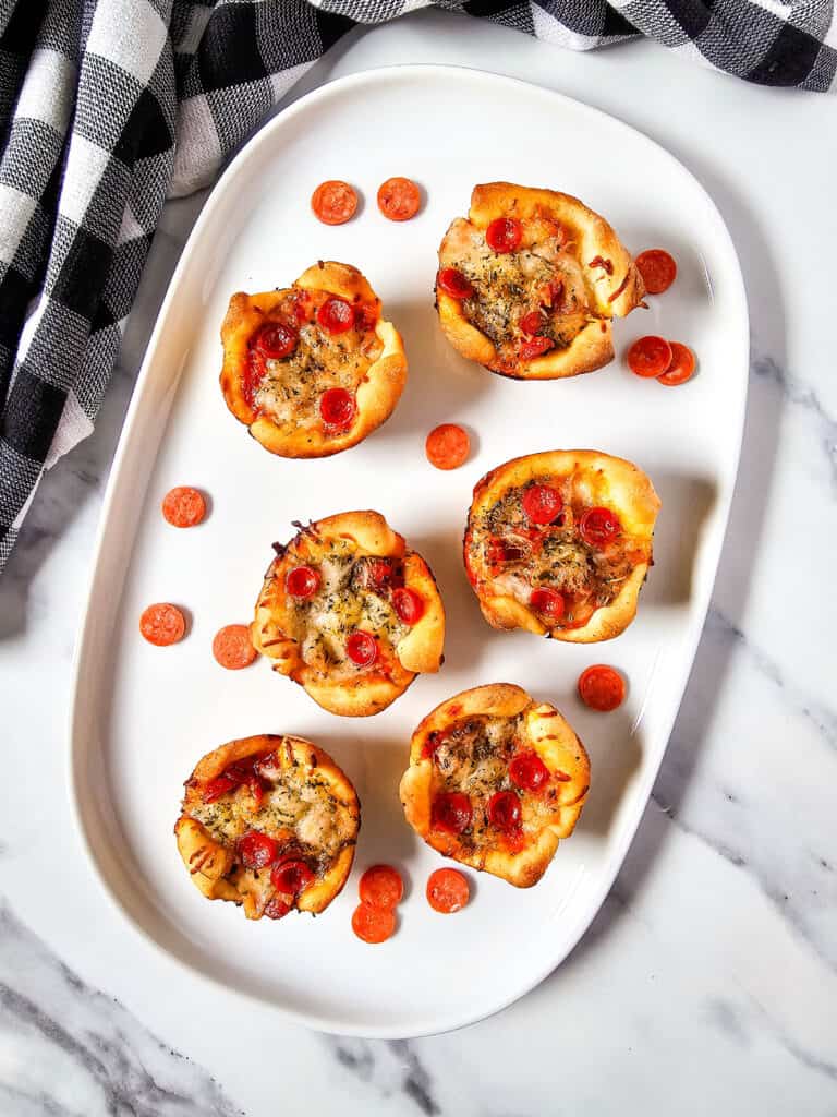Close-up of cheesy pepperoni pizza puffs served on a platter for game night.