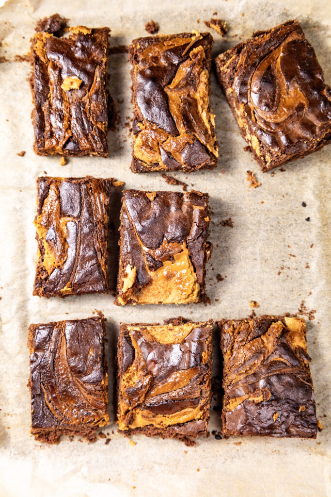  Decadent peanut butter brownie with rich chocolate layers and a golden peanut butter swirl on top.